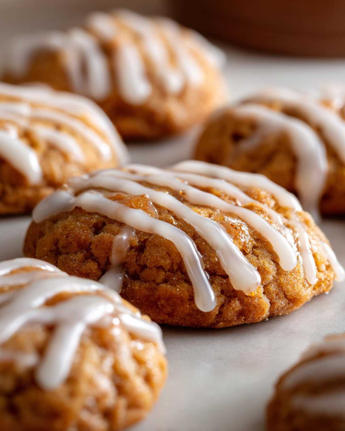 Close-up of glazed apple butter cookies, showcasing their texture and drizzled icing.