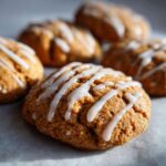 Close-up of glazed apple butter cookies. Soft, round cookies drizzled with white icing.