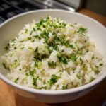 A white bowl filled with fluffy cilantro lime rice, a Chipotle copycat recipe.
