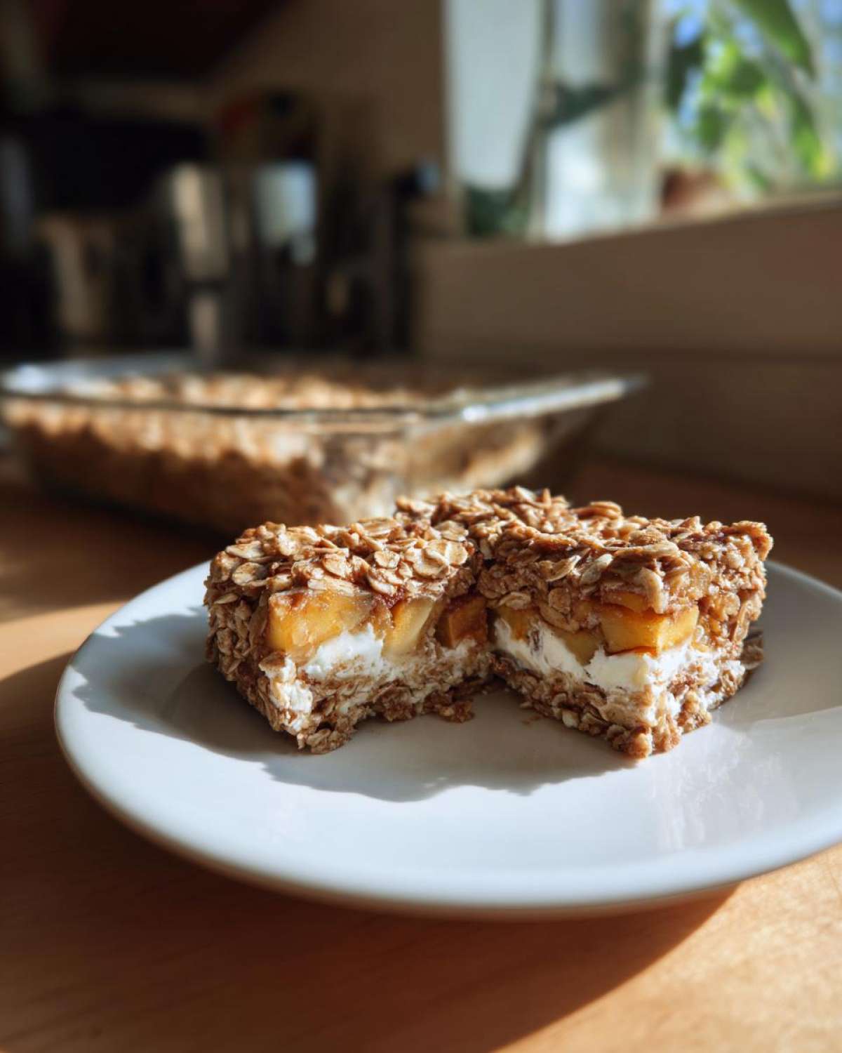A slice of apple cinnamon cottage cheese bake with layers of oats, apples, and cottage cheese filling.