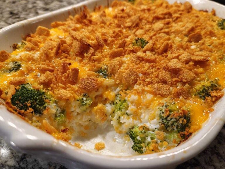 Baked broccoli rice casserole in a white dish, topped with cheese and crispy topping. Ready to serve.