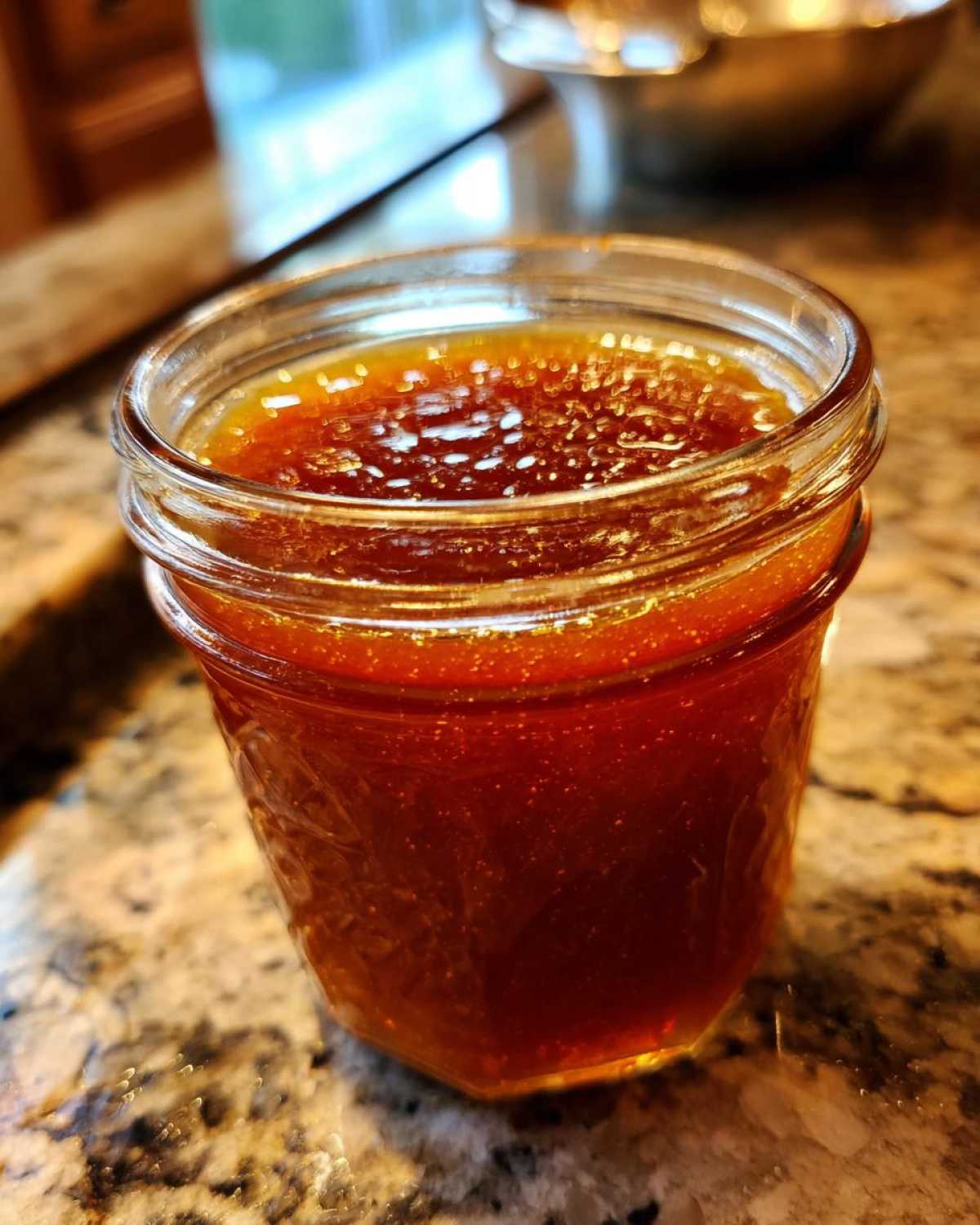 Close-up of a jar filled with delicious homemade honey BBQ sauce.