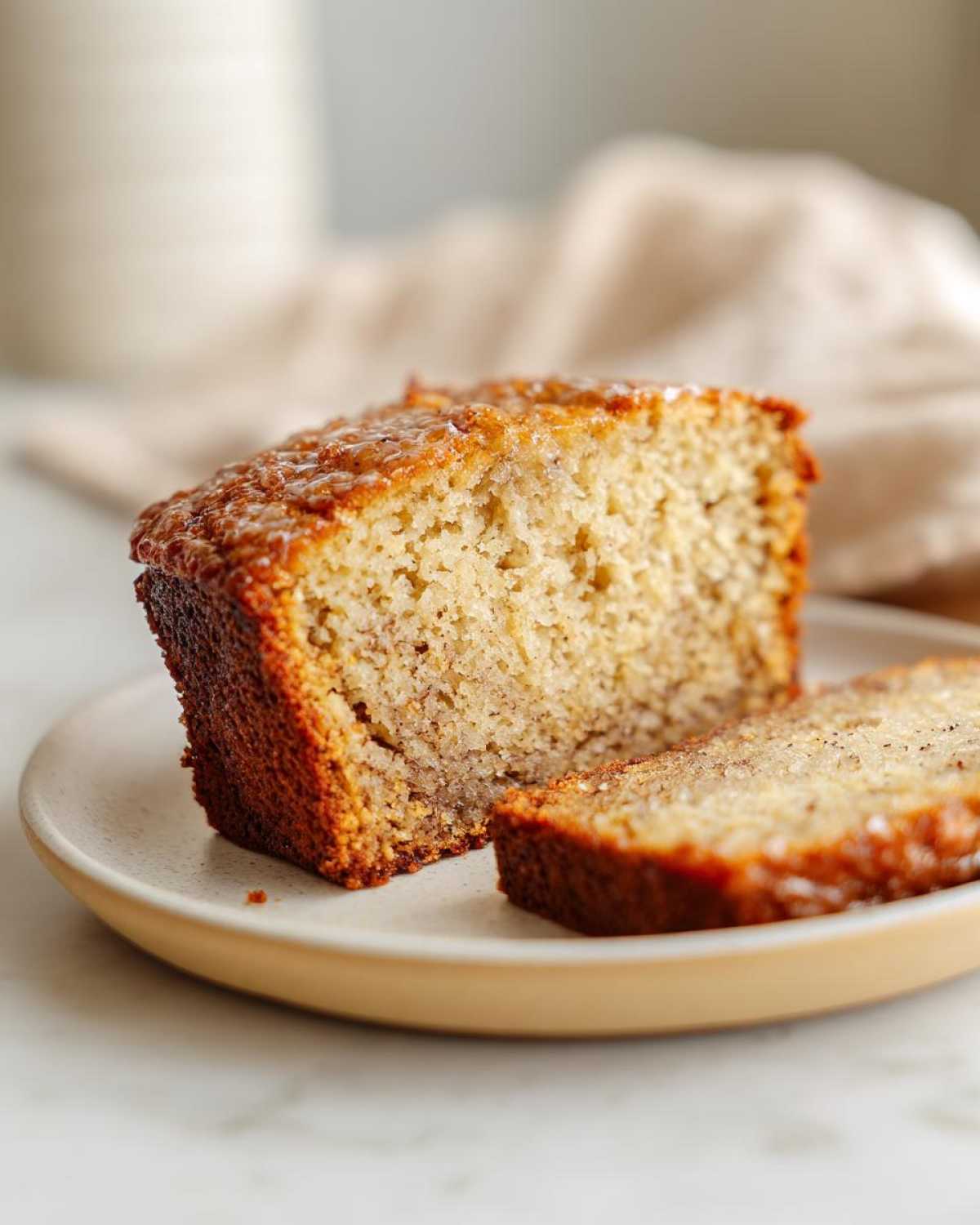 A slice of delicious honey vanilla banana bread on a plate, showcasing its moist texture.