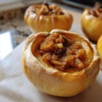 Close-up of pumpkin pie baked apples, showcasing the filling and baked apple exterior.