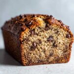A delicious loaf of chocolate chip banana bread, showcasing the moist texture and chocolate chips.