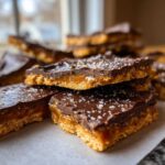 Close-up of rich, layered graham cracker toffee bars topped with melted chocolate and sea salt.