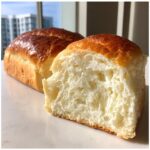 Close-up of a slice showing the incredibly soft, white interior of homemade condensed milk bread.