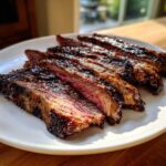 Close-up of perfectly cooked and sliced skirt steak showing a medium-rare interior and dark sear.