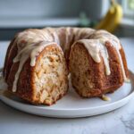 A sliced apple amaretto cake, a bundt cake filled with cooked apples and topped with a thick glaze.
