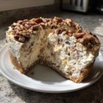 A rich, creamy pecan cream pie with a slice cut out, showing the thick filling and pecan topping.