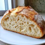 Cross-section view showing the airy, open crumb structure of the fluffy yeast bread recipe.